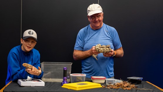 Bent Christensen and son are showing a snake and a lizzard.