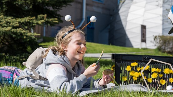 A teenage girl is exploring as a bee.