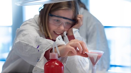 A teenage girl extracts DNA from strawberries